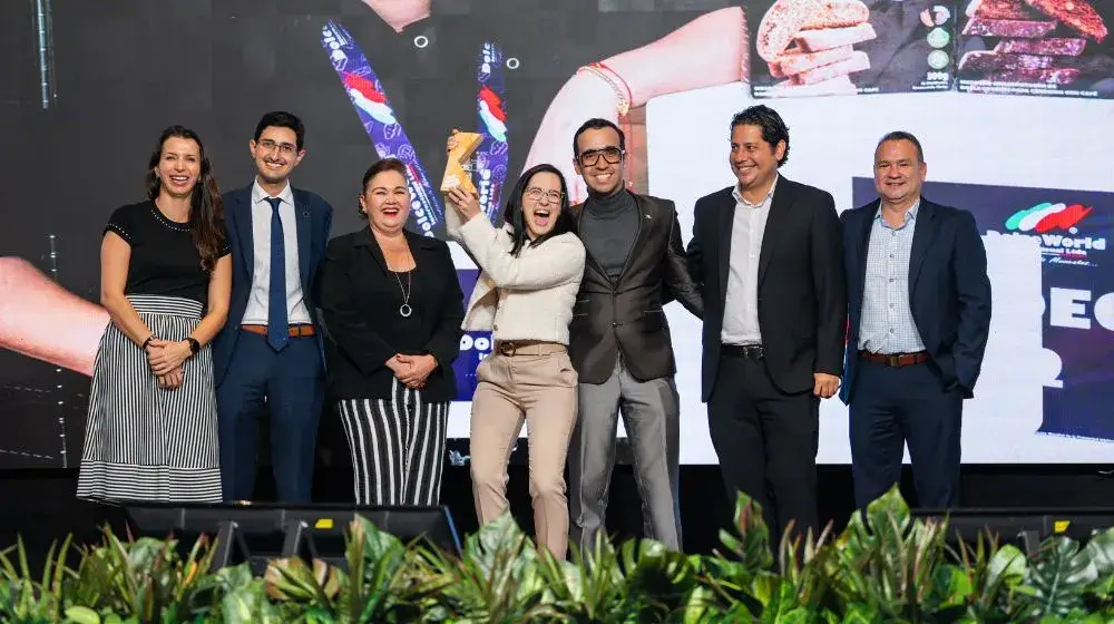 Persona ganadora celebrando con las gerencias de BAC el premio del concurso BAC Positivo